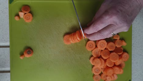 elderly chef chopping carrots preparing ingredients for soup