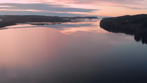 golden twilight cloudscape reflection in lake. aerial landscape