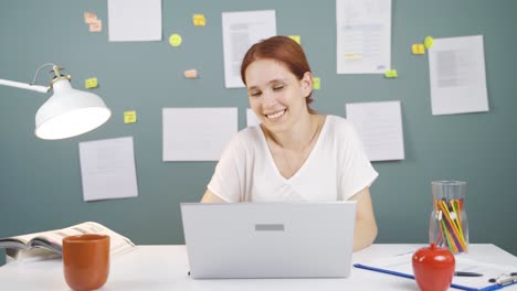 Woman-looking-at-laptop-is-happy-and-dancing.