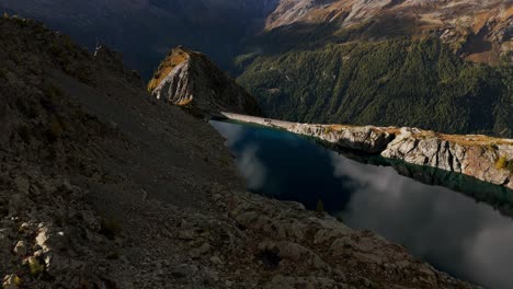 aerial view of stunning alpine lake and dam in the mountains