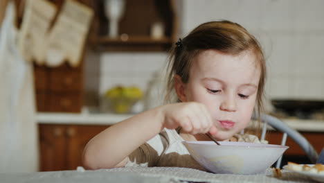 sweet girl 5 years eating soup in the kitchen 4k video