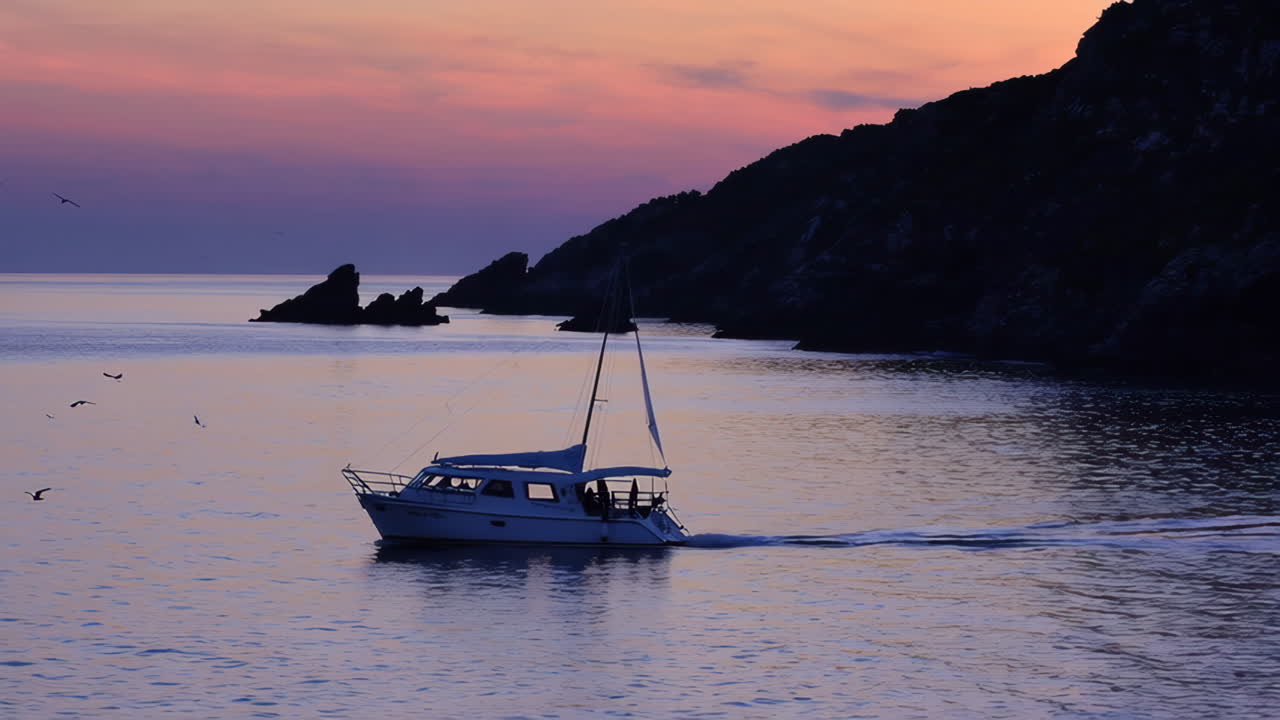 Sunset Sailboat on Rocky Coast