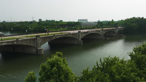 pedestrian bridge with arches across the white river in downtown indianapolis, indiana