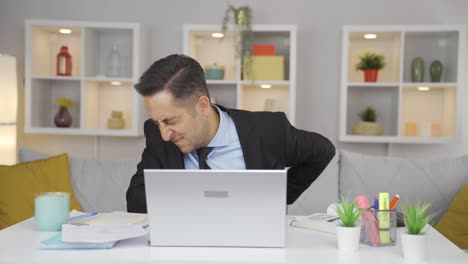 home office worker man has lower back pain.