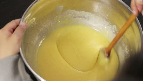 children making a cake at home, close-up soft focus