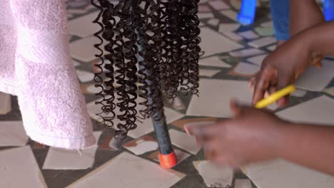 hairstylist using sharp scissors to trim the ends of extensions