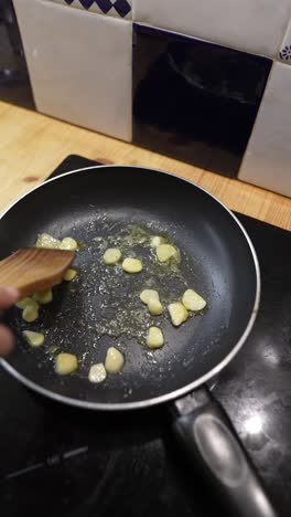 frying garlic in a pan