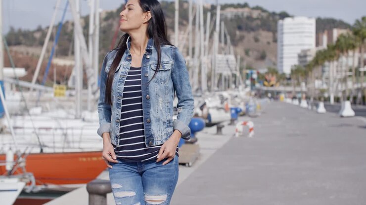 Casual woman enjoying a walk through a marina