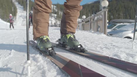 A-skier-puts-on-skiis,-winter-in-Åre,-Sweden