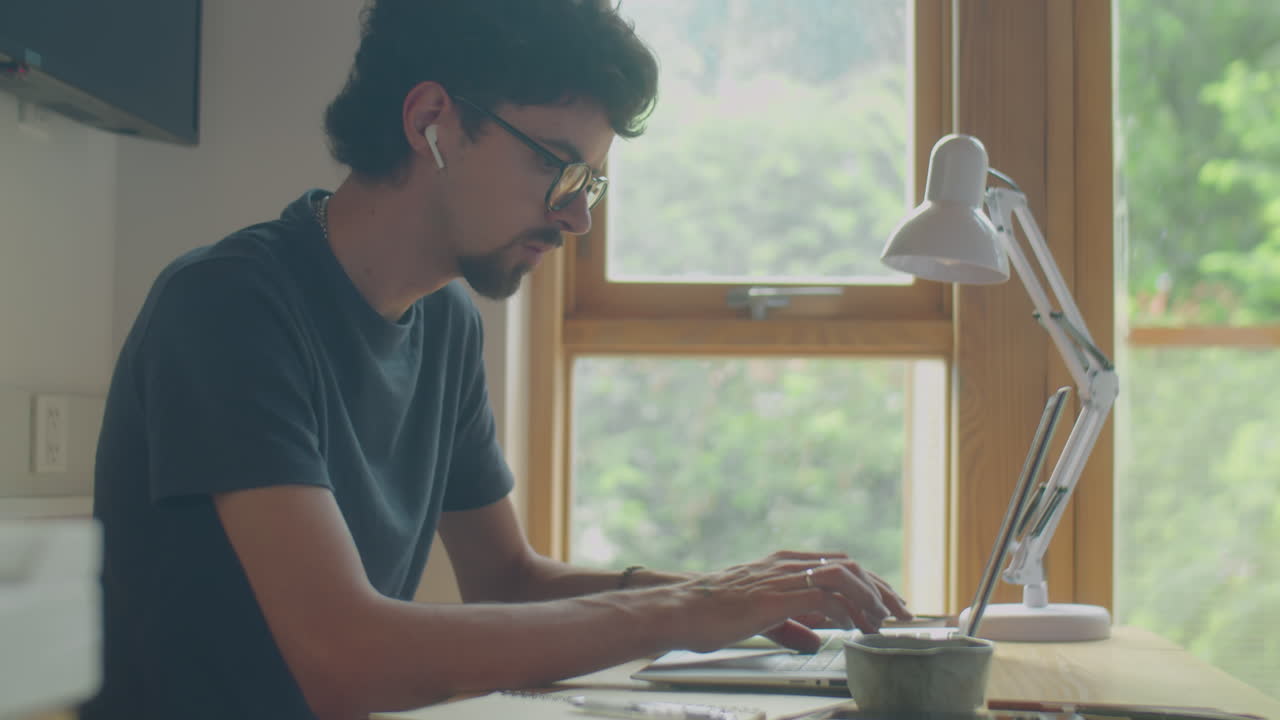 Male Freelancer Working on Laptop from Home