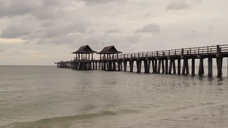 wooden pier over the ocean on a cloudy day