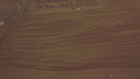 Beach-with-deck-chairs-and-blue-ocean-aerial-view