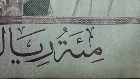 this is the macro view of a normal paper bank not- money- currency ofsaudi arabia 100 riyals bill