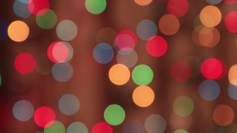 festive multicolored flickering lights in the dark with a slow red beam.