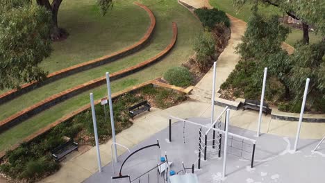 aerial view rising above empty childrens play park, australia