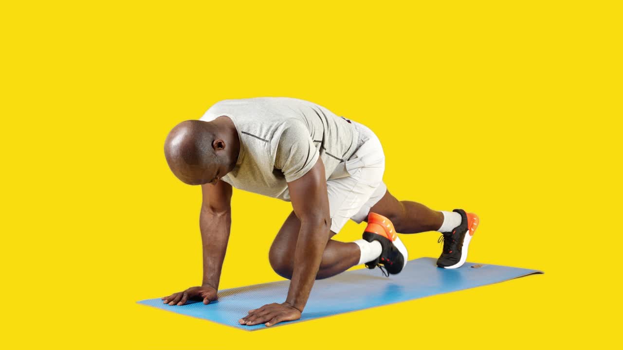 Man Performing Mountain Climber Exercise on Yoga Mat