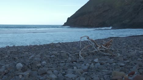 camera captures the continuous ebb and rise of waves on the rocky beach of serra de dentro