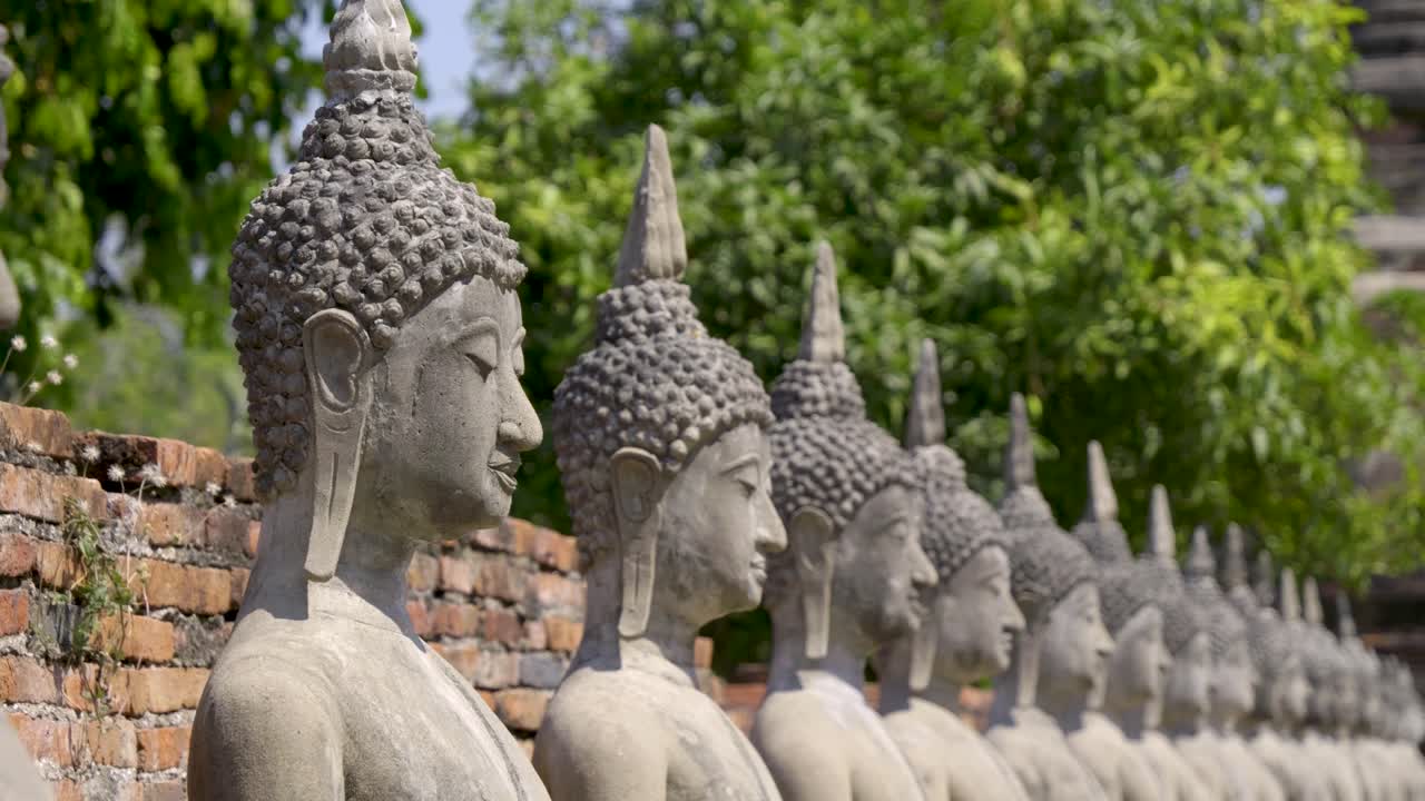 Close up over heads of Buddhist statues in Thailand