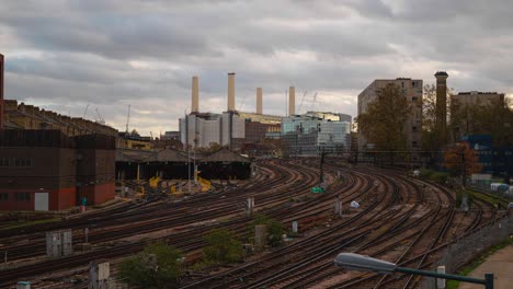 Timelapse-of-Battersea-Power-station-on-a-cloudy-day-with-London-intercity-train-tracks-in-front