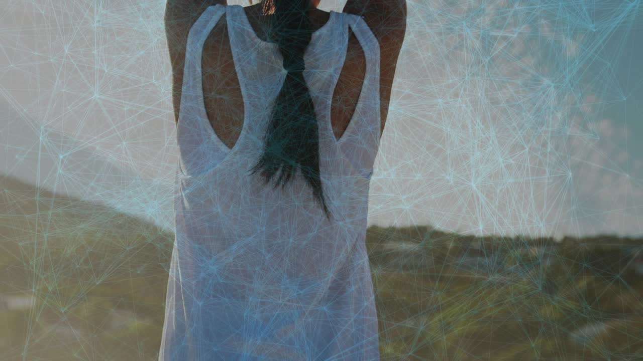 Woman gradually lifting arms after sunlight flare, forming palms-together yoga posture for wellness