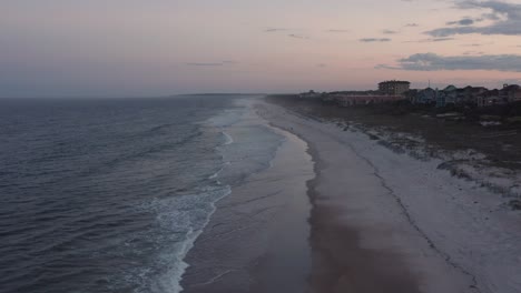 Aerial-view-over-a-beach-just-before-sunset