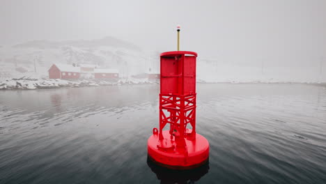 red buoy in a foggy winter seascape