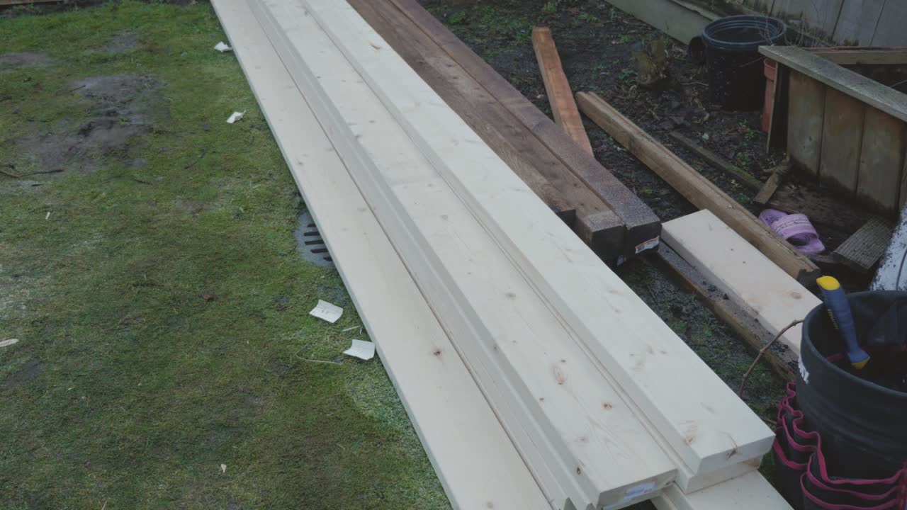 madera apilada en el patio trasero de hierba para el proyecto de construcción de mejora de hime diy patio cubierta