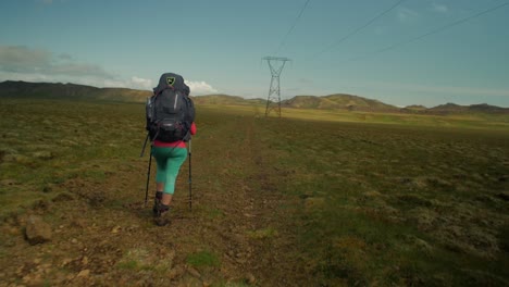 dramatic iceland landscape, person hiking on trail, camera following movmement, camera tracking - dolly in on a steadicam gimbal stabiliser