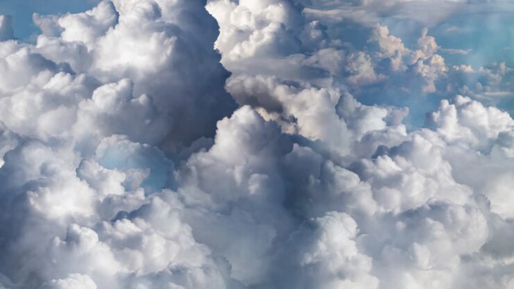 point of view, thick cumulus clouds are moving closer in the clear blue sky