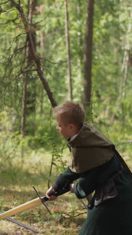 knight teaches boy to fight with sword, ammunition, historical costumes of medieval era