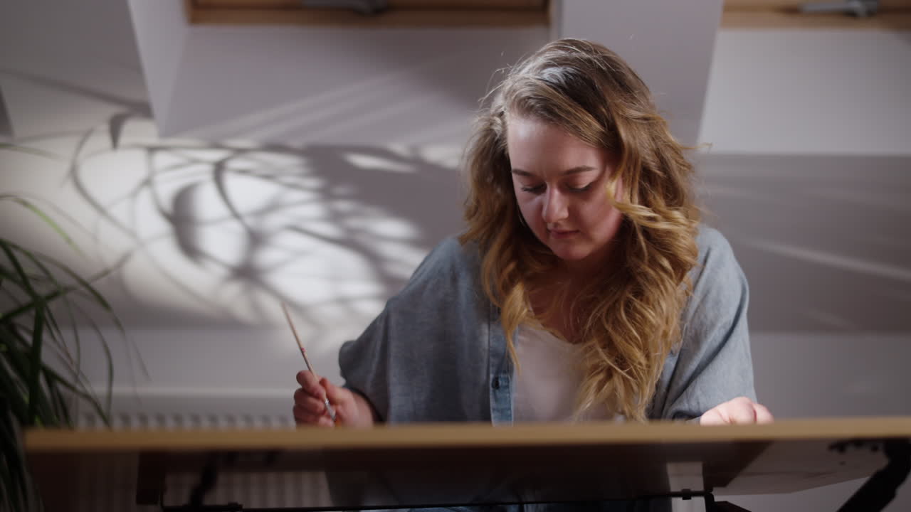 Woman Drawing at a Desk