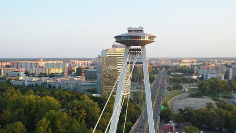 Cinematic-drone-shot-of-the-Bridge-of-the-Slovak-National-Uprising-flying-near-the-observation-deck-in-Bratislava,-Slovakia