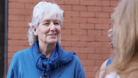 two aged woman talking on the street