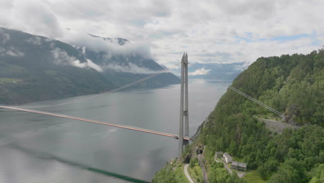 wide angle establishing shot large bridge over fiord in mountain valley