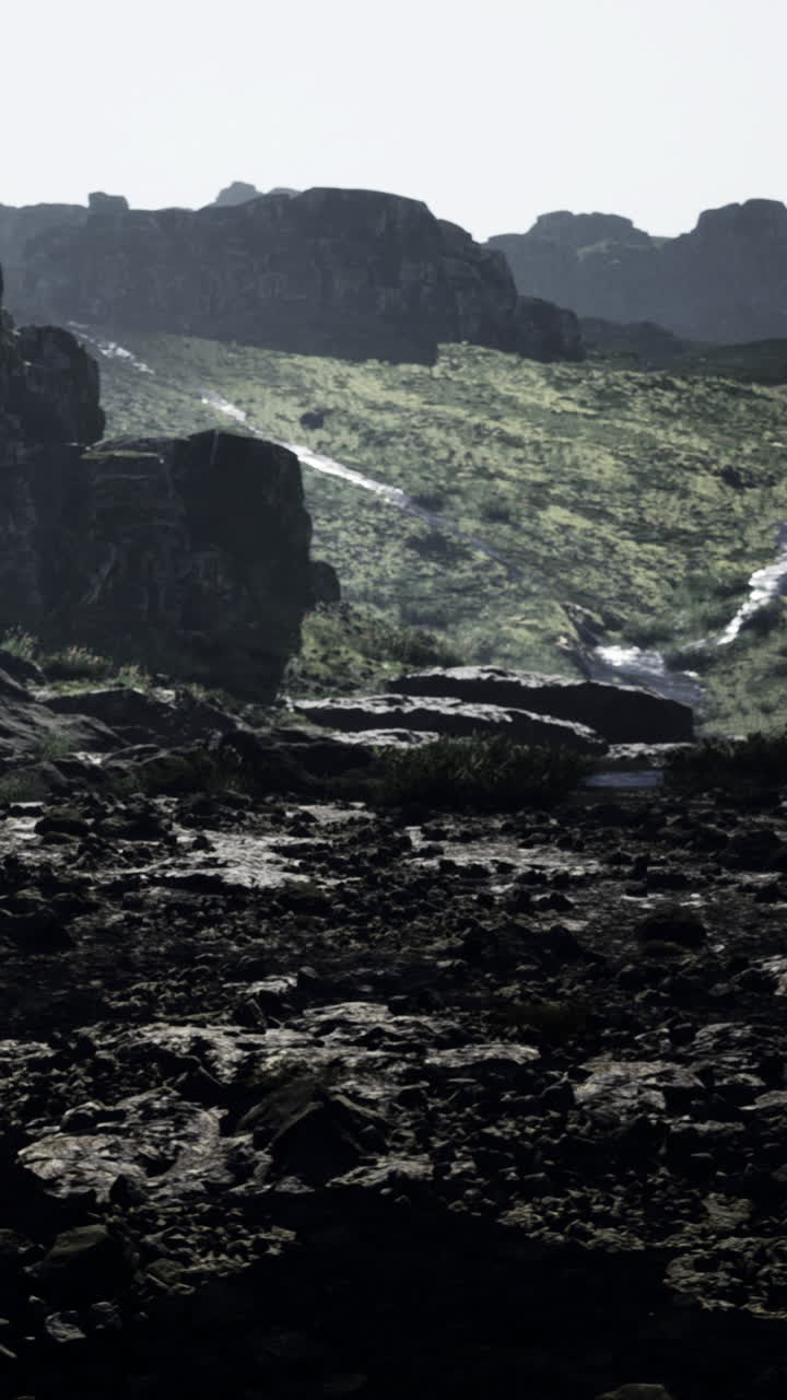 Moody landscape with rocky terrain and stream under low light conditions