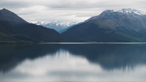 Peaceful-snow-capped-mountain-reflections-in-still-quiet-Lake