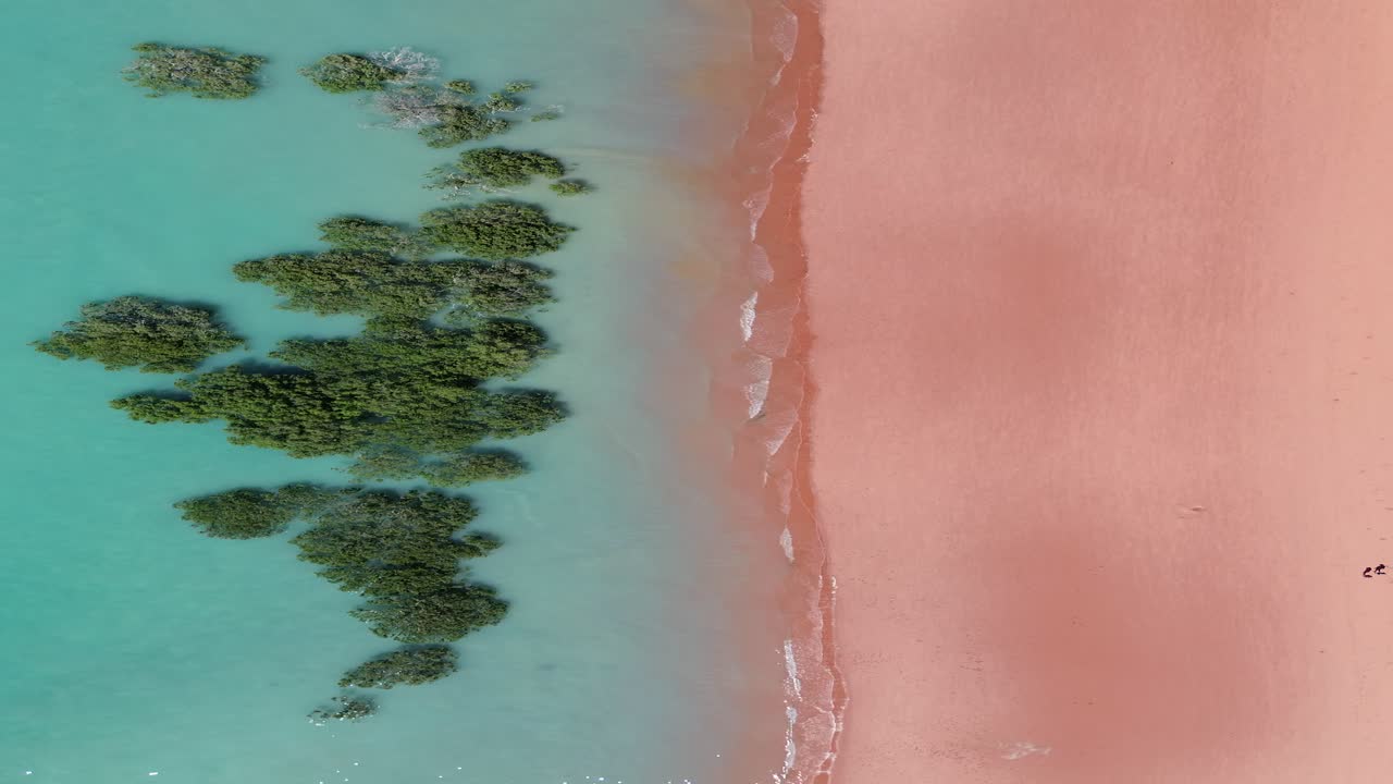 Stunning aerial footage of the vibrant coastline in Broome, featuring red sand, turquoise waters, and natural beauty captured from above in Western Australia.