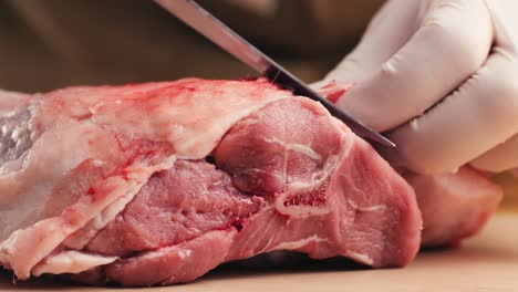 chef cutting raw lamb