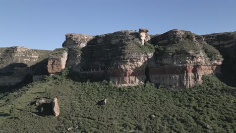 Aerial-orbits-steep-stone-cliff-"Camel-Rock"-near-Fouriesburg,-ZA