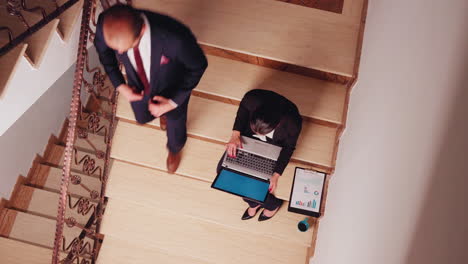 Top-view-of-focused-woman-analyzing-statistics-on-laptop