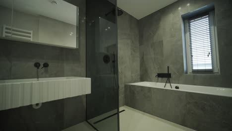 elegant modern bathroom with dark tile accents