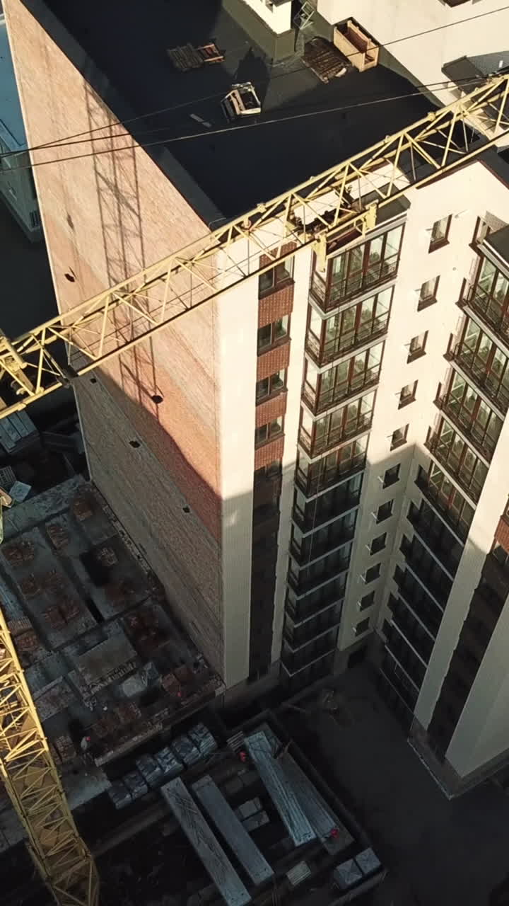 Crane for building. Crane for constructions of large building working on building Vertical video