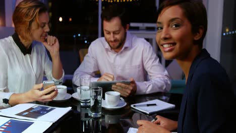 Businessman-discussing-work-on-digital-tablet-with-colleagues