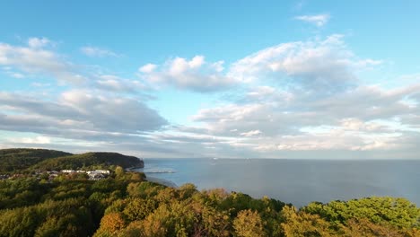 Aerial-Rising-Over-Over-Autumnal-Forest-Trees-In-Gdynia-With-Baltic-Sea-In-Distance