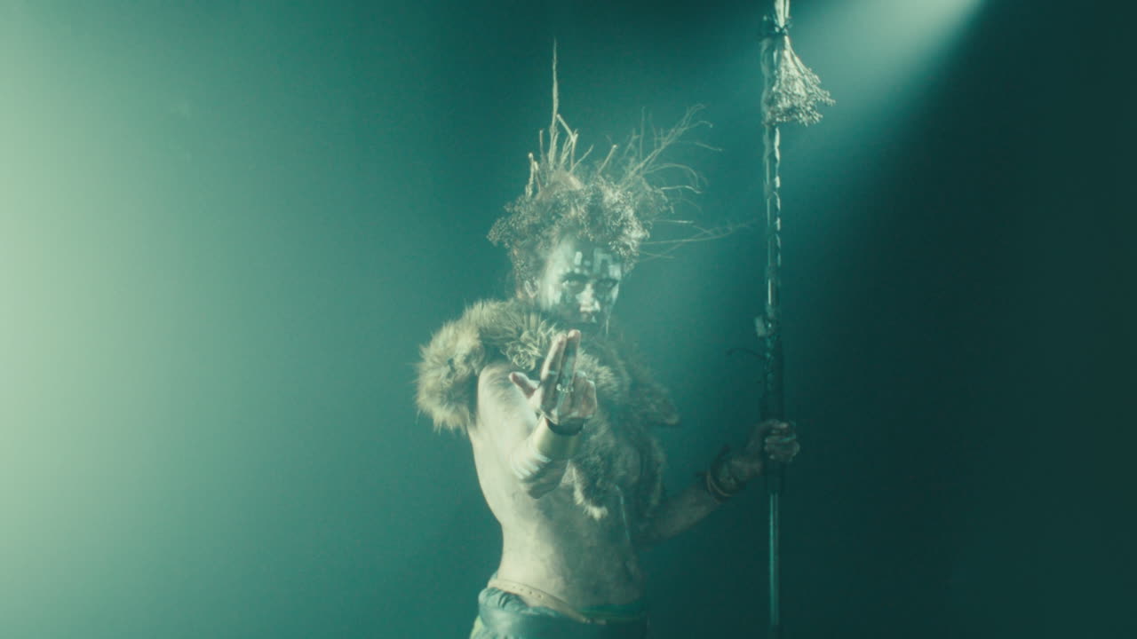 The witch makes a beckoning gesture with her hand