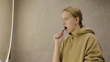 teenage girl brushing teeth