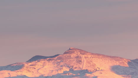 Snowy-Sierra-nevada-veleta-peak-in-Granada,-Andalusia,-Spain-during-sunset-timelapse