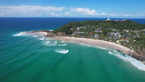 waves coming to the sandy shore of wategos beach in byron bay, nsw, australia