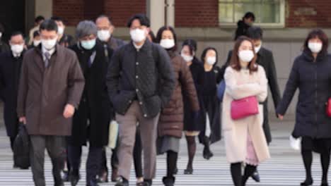 commuters waling crowded tokyo station on the way to work