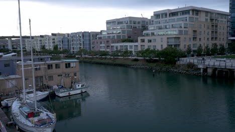 urban waterfront with residential boats and modern apartment buildings